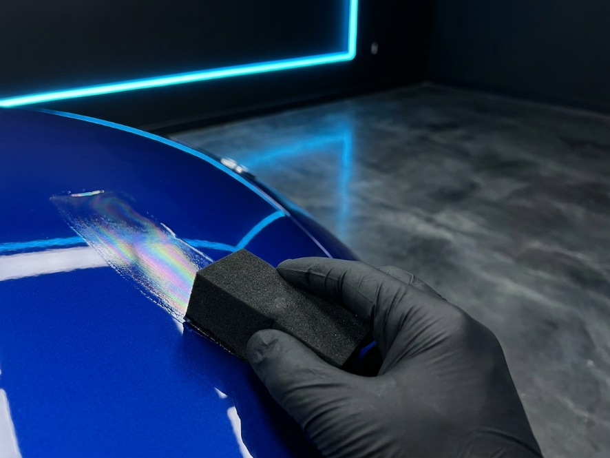 Ceramic coating applicator leaving a rainbow sheen on blue paint